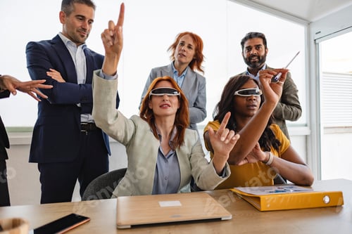 Preview: Business team experiencing virtual reality during meeting