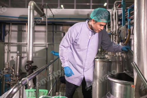Preview: Worker Checking quality or checking stock of glass bottle in beverage factory.