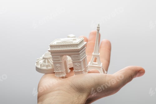 Preview: cropped view of man holding small souvenirs from paris isolated on grey