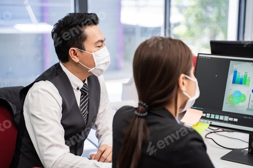 Preview: Group of Asian team business people working in office with new normal social distancing lifestyle