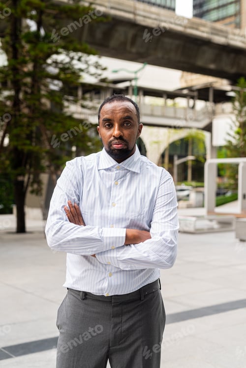 Preview: Portrait of handsome black man in city ready for business