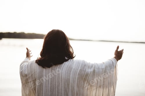 Preview: Biblical scene - of Jesus Christ with his hands up and a bright sky in the background