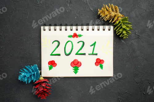 Preview: top view note with tree toys on a dark background color photo copybook new year xmas