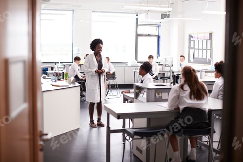 Preview: Female High School Tutor Teaching High School Students Wearing Uniforms In Science Class
