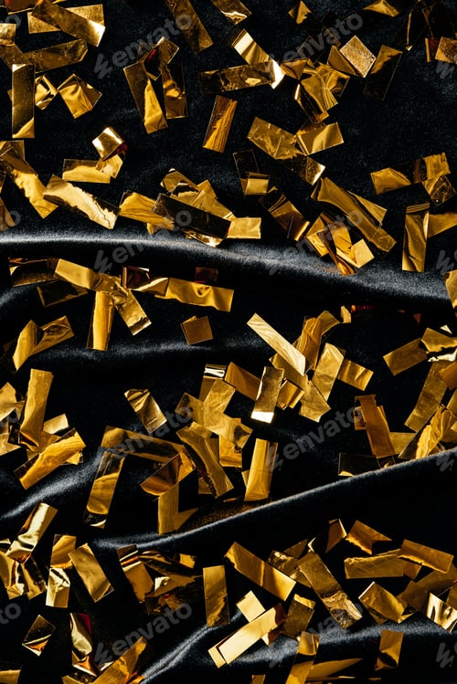 Preview: full frame of golden confetti on black backdrop
