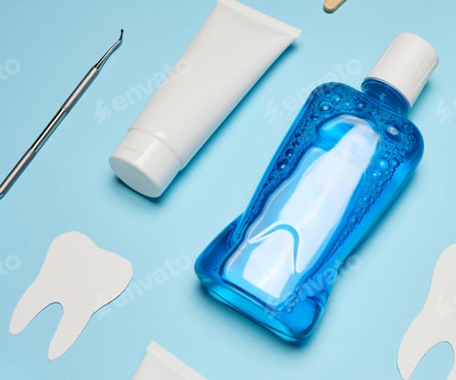 Preview: Mouthwash, toothpaste tube, dental floss on a blue background, oral hygiene