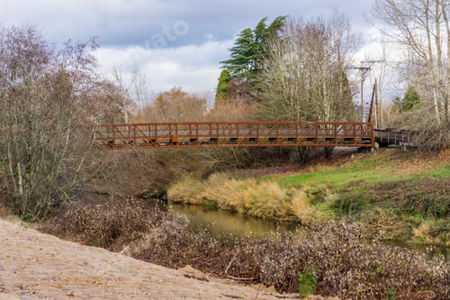 Preview: A Metal Walking Bridge Spans The Green River In Kent, Washington.