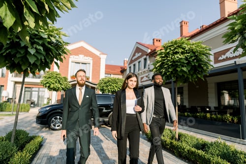 Preview: Three Multiethnical Business Colleagues Walking Outside Office, going on the business meeting