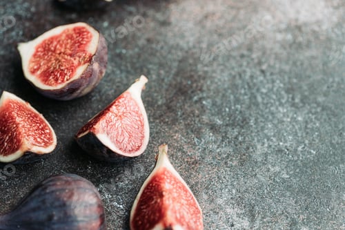 Preview: Macro photography of fresh ripe cutted figs on the textured background.