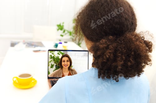 Preview: Shot of attractive afro female doctor talking while explaining medical treatment to patient