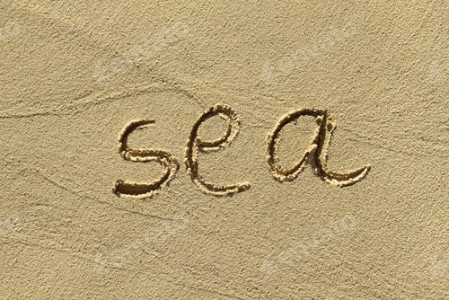 Preview: Natural sand background with scrawled word ''Sea''
