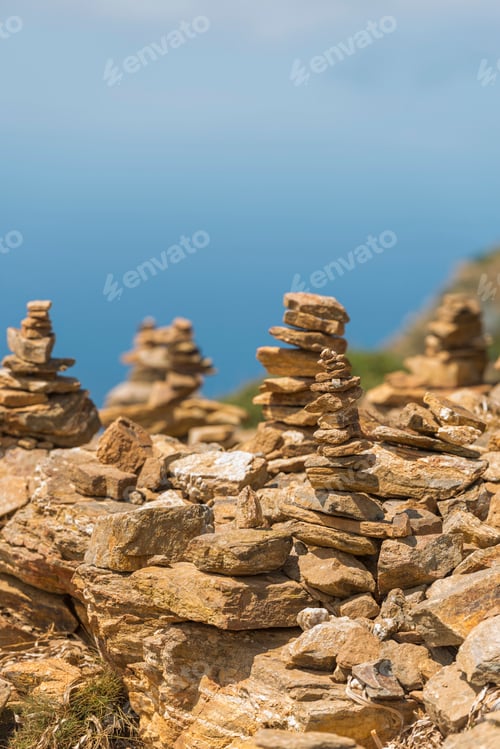 Preview: the rocks have stacks and pebbles on it against the backdrop of a large