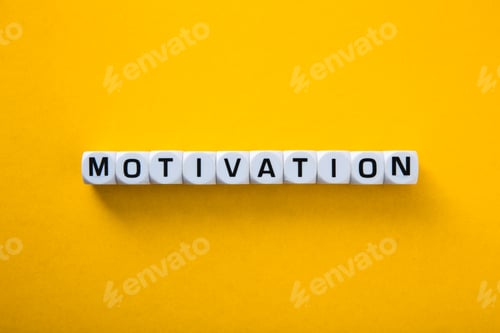 Preview: Motivation word is written with plastic letter cubes on a yellow background