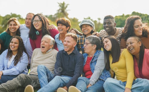 Preview: Crowd of happy multiracial people hugging each other outdoor while smiling in front of camera
