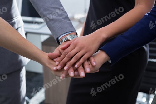 Preview: Group of executives stacking hands over each other