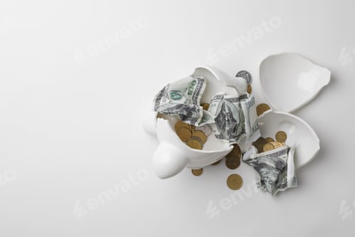 Preview: Broken piggy bank with coins and banknotes on white background