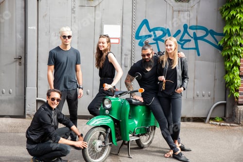 Preview: Group of five black dressed friends with green moped