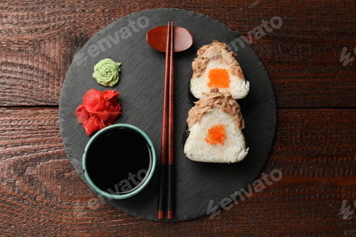 Preview: Tasty onigiri (Japanese rice balls) with tuna served on wooden table, top view