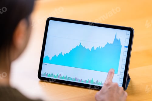 Preview: Back rear of woman study on the stock market graph on digital tablet computer