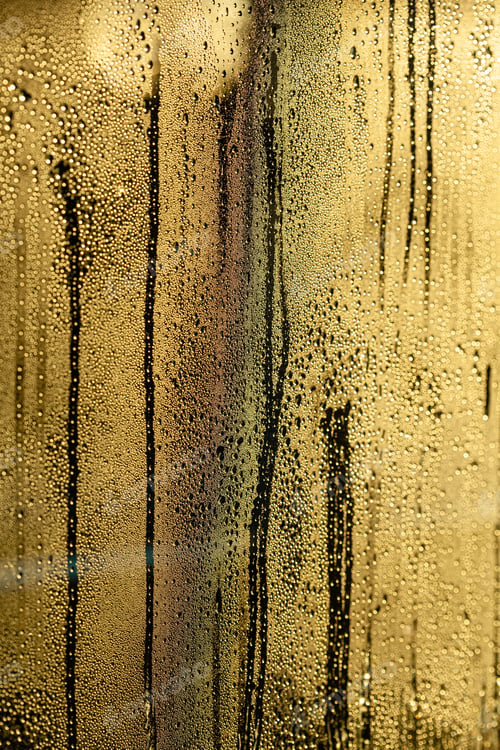 Preview: rain drops on window glowing golden abstract background