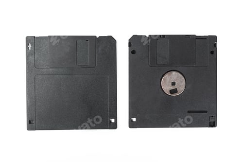 Preview: Old black floppy disks on a white background for data storage and retrieval