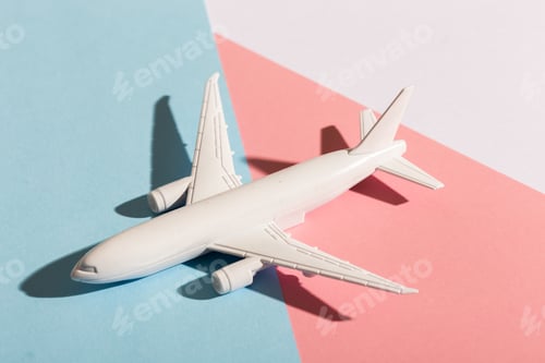 Preview: Model plane airplane on pastel blue and pink color background. Flat lay design. Flight and aircraft