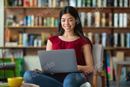 Preview: Asian Student Girl Watching Webinar On Laptop At Cafe, Sitting In Chair