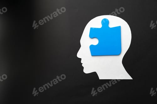 Preview: Papercut head with jigsaw puzzle pieces on black background