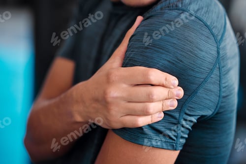 Preview: Hand, shoulder and injury with a sports man holding a joint in pain while training in a gym for hea