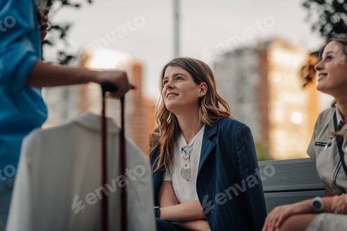 Preview: Businesswomen listening to colleague explaining during business trip