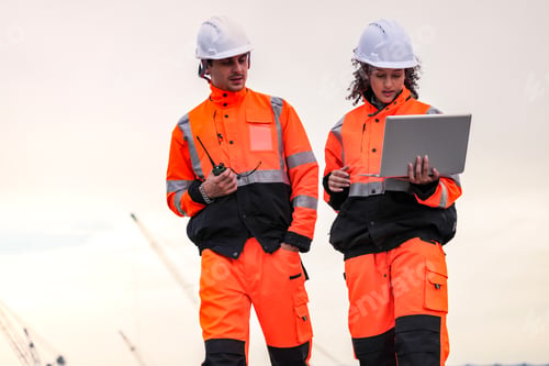 Preview: Two port engineers communicate while inspecting dockside logistics