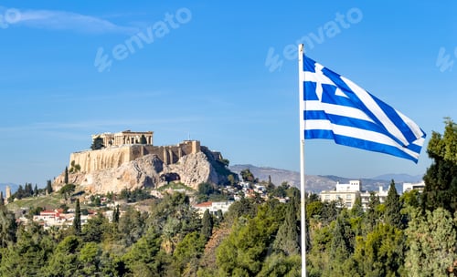 Preview: Greek flag waving beside the Acropolis and Parthenon within bright daylight over Athens, Greece