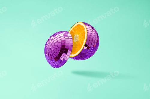Preview: Cut disco ball as an orange, floating in the air on a green background.
