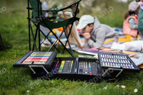 Preview: Drawing set outdoor on picnic blanket painting at garden spring park, relaxation.