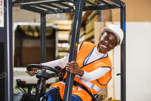 Preview: Happy worker driving forklift in lumberyard warehouse