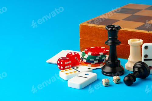 Preview: Items for playing chess, poker and domino on blue background studio shot