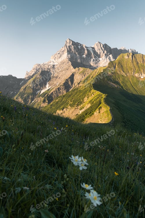 Preview: Vertical shot of the beautiful Dents du Midi mountain ridge after sunrise in Switzerland