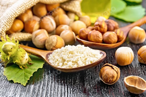 Preview: Flour and hazelnuts in two spoons on board
