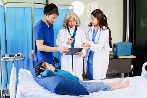 Preview: A doctor listens to a little girl’s heartbeat with stethoscope while she lies on a bed in hospital