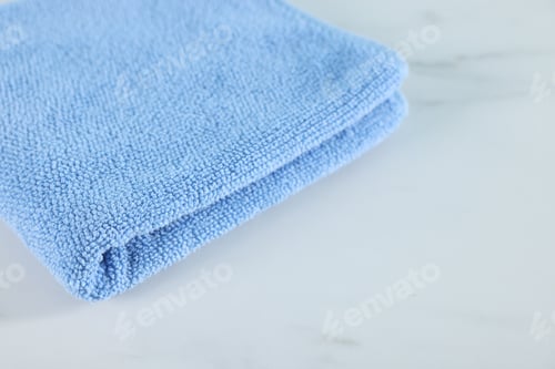 Preview: Clean towel on white marble table, closeup