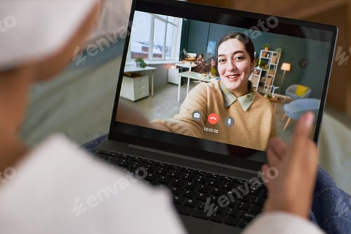 Preview: Young Caucasian Woman Smiling While Video Chatting during Online Dating