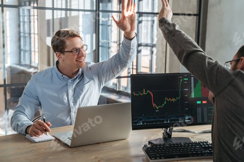 Preview: Two partners crypto trade investors giving high five to each other after fulfilling good deal
