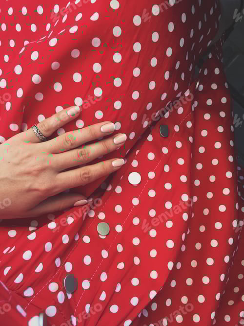 Preview: Hand with Ring on Red Polka Dot Dress