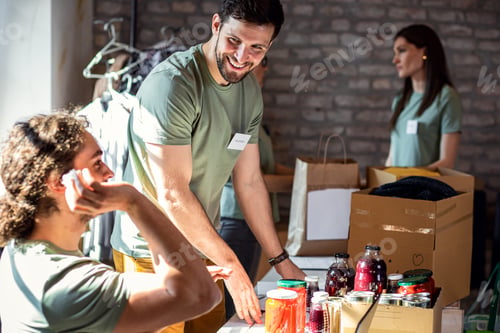 Preview: Group of volunteers with working in community charity donation center.