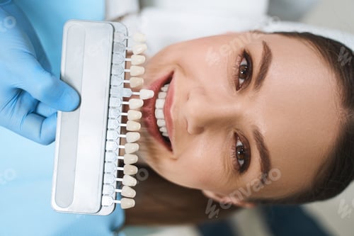 Preview: Smiling woman is choosing veneers stock photo
