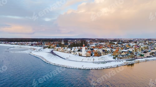 Preview: Drone view of the Lighthouse of Urk during winter with snow in the Netherlands