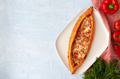 Preview: Turkish baked Pide bread on light blue wooden surface