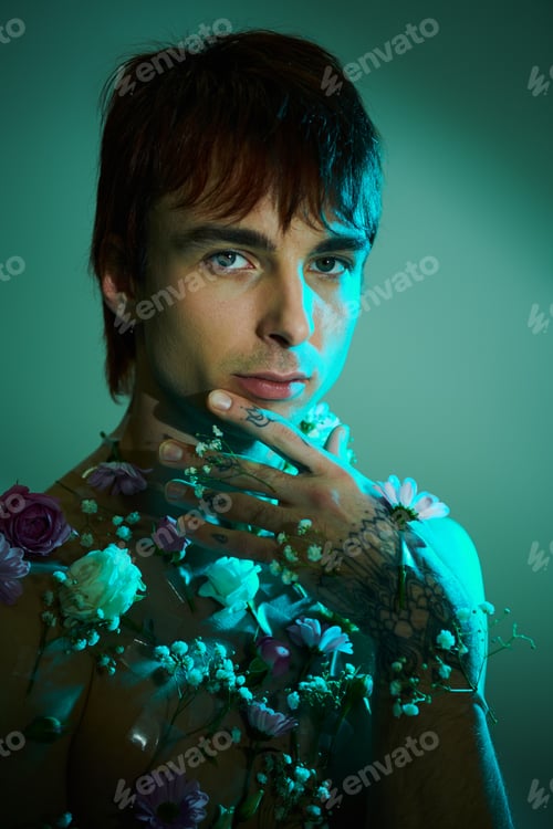 Preview: Floral ink: young man bares chest with tattoos and flowers