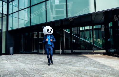 Preview: Storytelling image of a business man wearing a giant panda head
