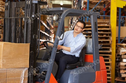 Preview: Man Driving Fork Lift Truck In Warehouse